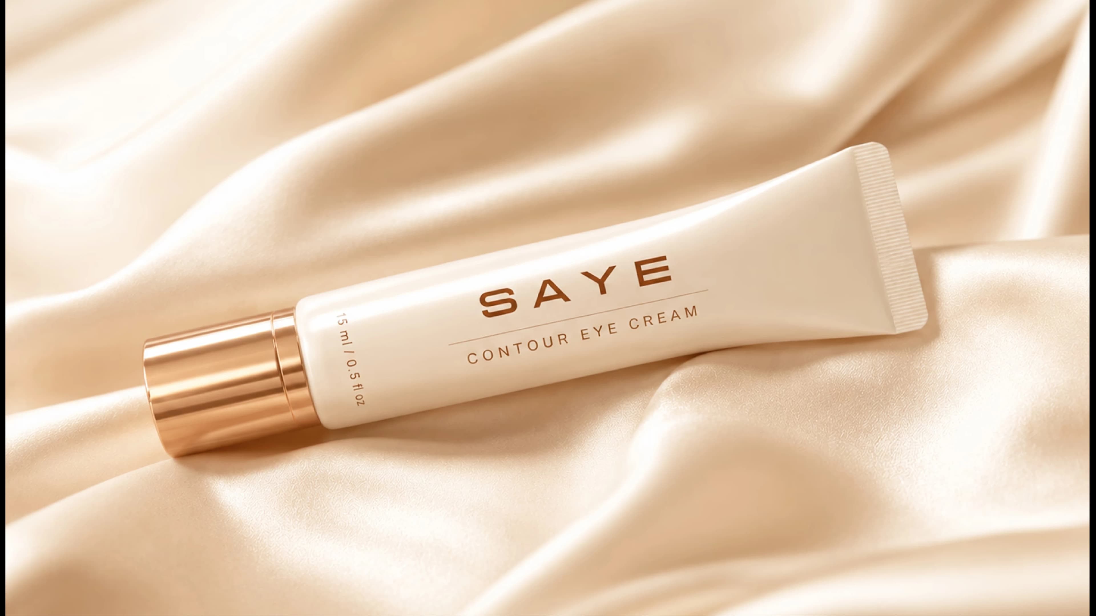 SAYE Contour Eye Cream tube close-up on silk fabric