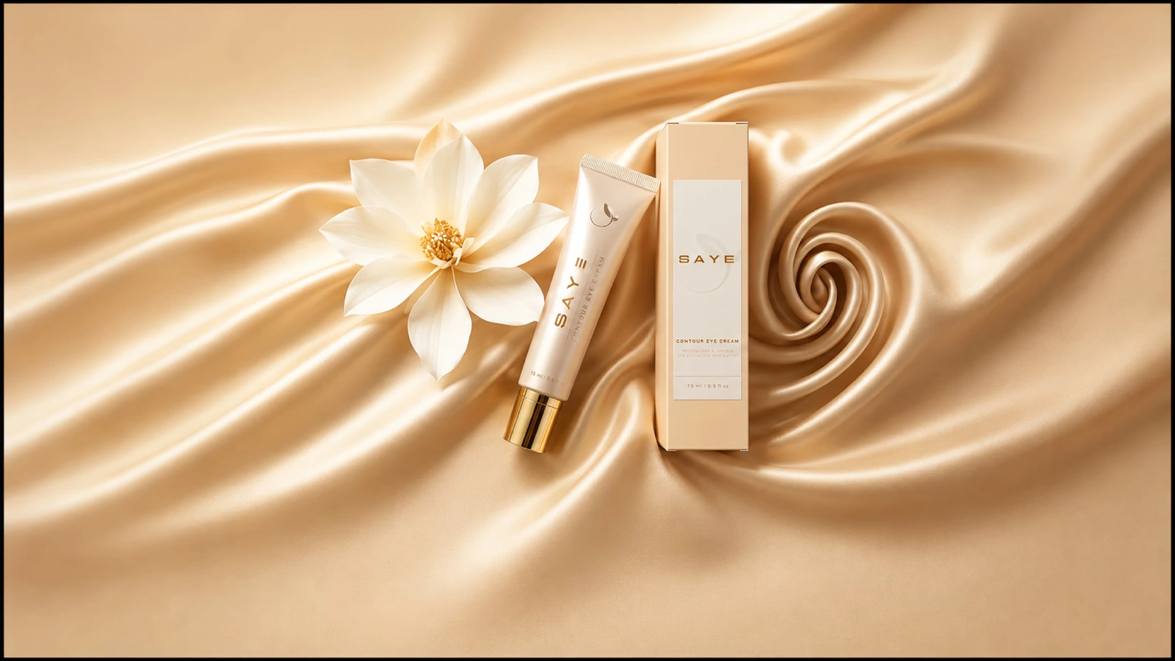 SAYE Contour Eye Cream tube, box, and flower on silk fabric